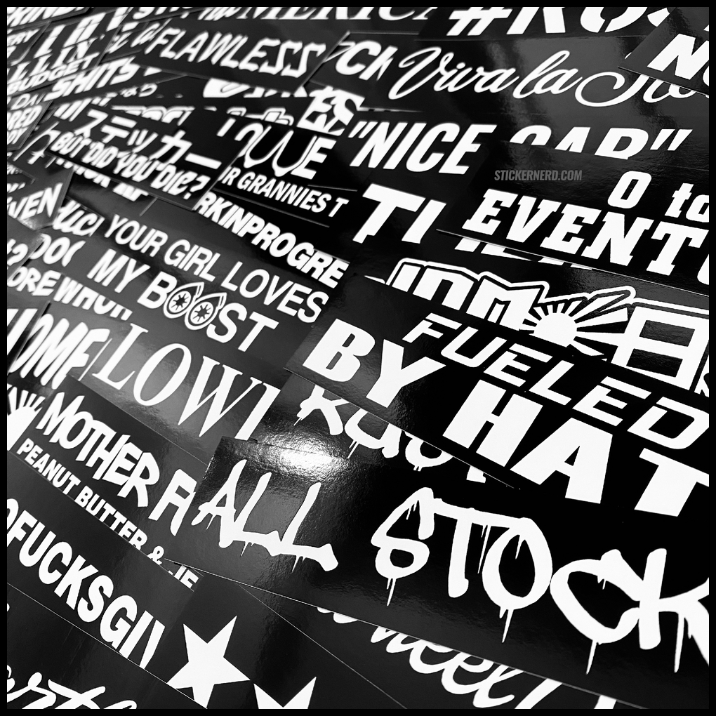 Collection of black and white stickers with various phrases and designs.
