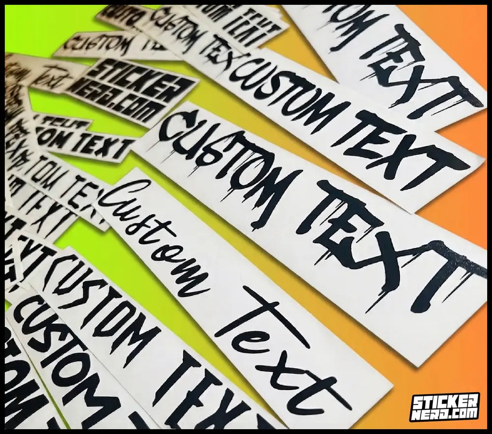 White rectangular decals with black dripping-style text reading 'CUSTOM TEXT' arranged diagonally on a bright yellow and orange background. Multiple copies of the same decal are visible.