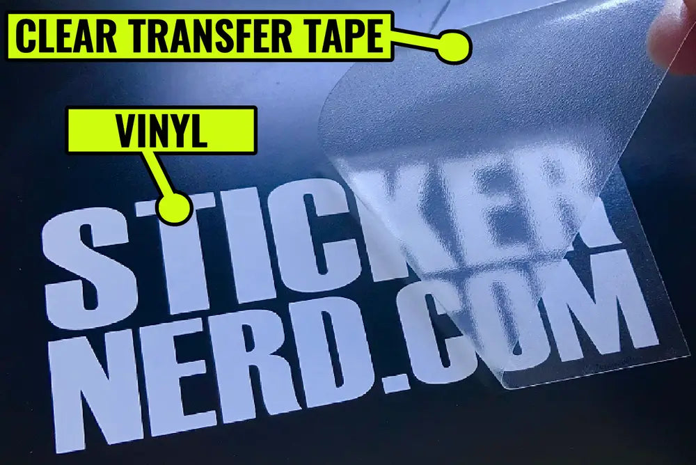 A close-up of a clear vinyl sticker being peeled back from a dark surface. The sticker reads 'STICKER NERD.