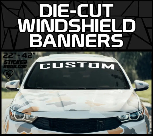 Die-Cut Windshield Lettering banner featuring a custom white text decal on a camouflage wrapped car windshield