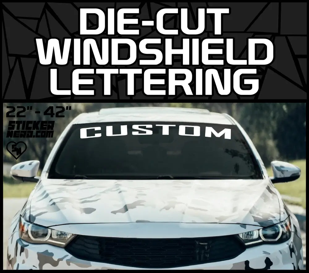 Die-Cut Windshield Lettering banner featuring a custom white text decal on a camouflage wrapped car windshield